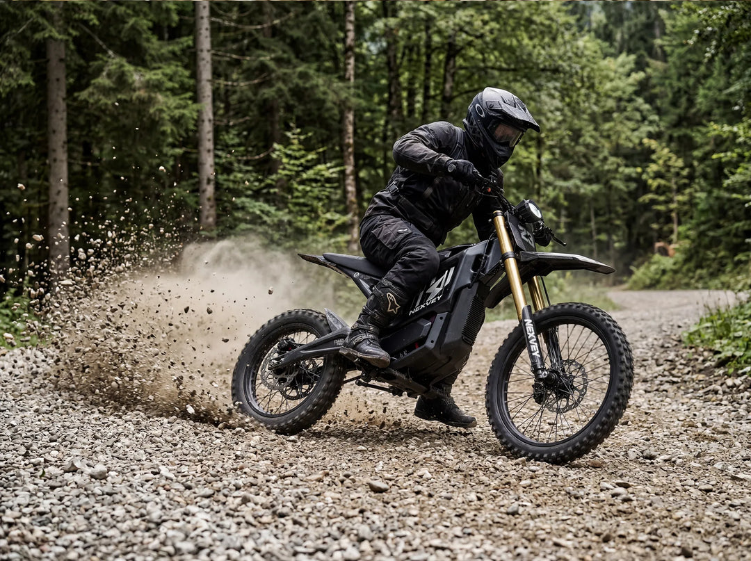 A rider on the Nexvey Flash Pro electric dirt bike drifting on a gravel trail with rocks flying, showcasing its powerful off-road performance and youth adventure spirit.