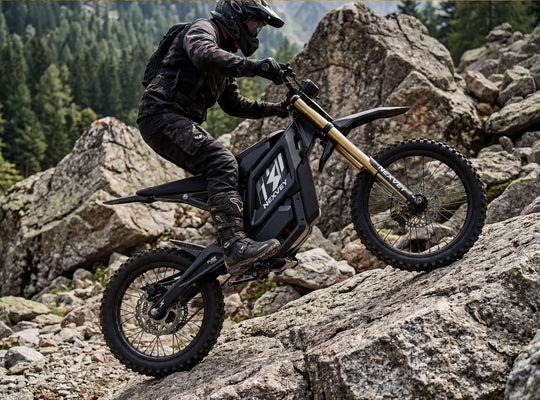 A rider expertly maneuvering the Nexvey Flash Pro electric dirt bike across large rocks on a mountainside, demonstrating heavy-duty suspension and all-terrain capabilities for youth adventures