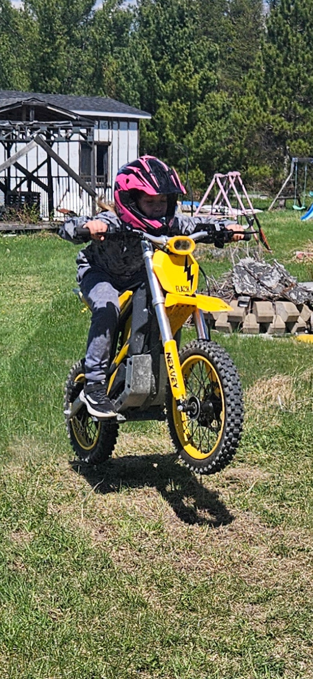 Yellow NEXVEY Flash electric dirt bike rider in a forest