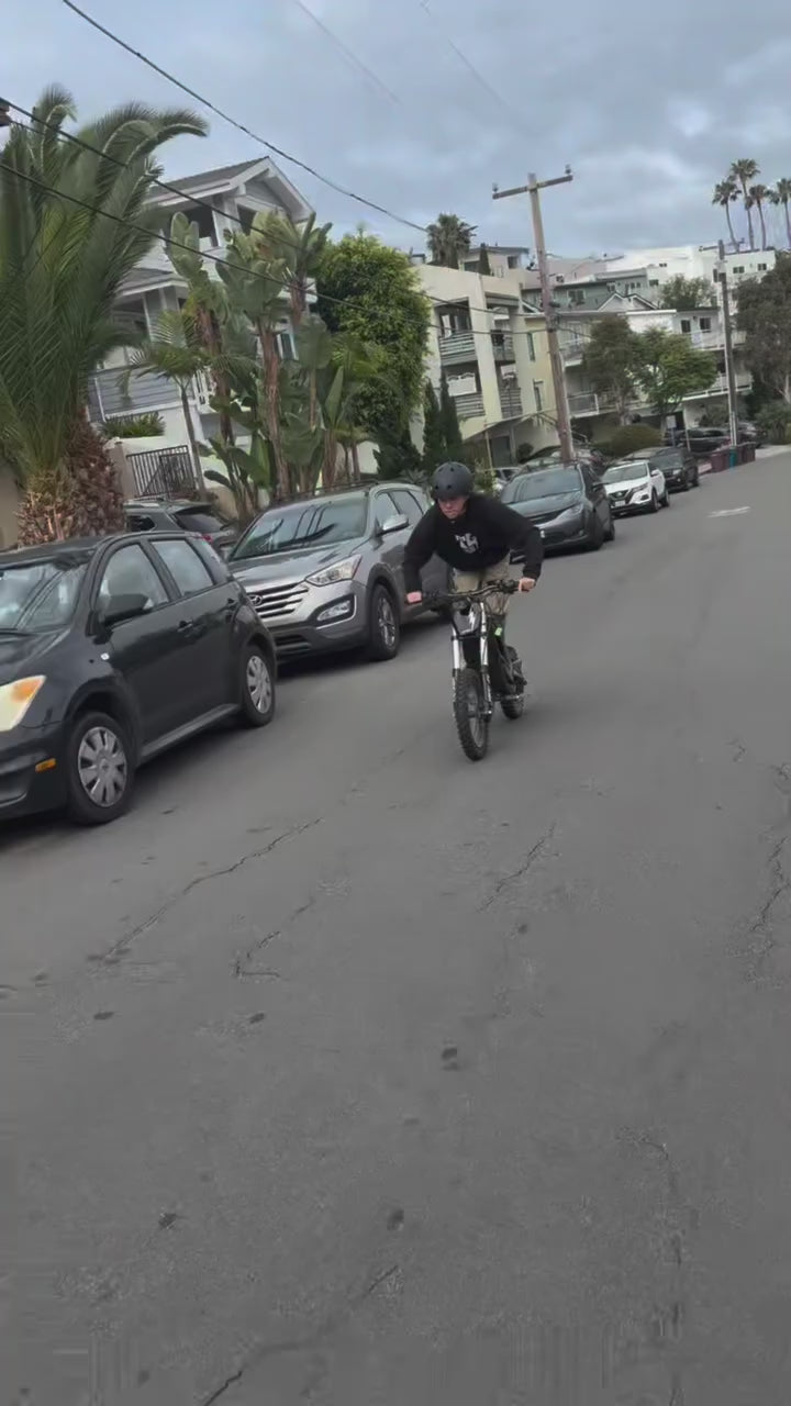 Greyson Narlock performing advanced street stunts on a Nexvey Flash black electric dirt bike.