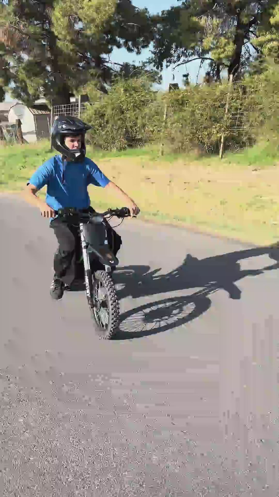 Influencer Ander Surron riding a Nexvey electric motorcycle and performing stunts on a USA city street