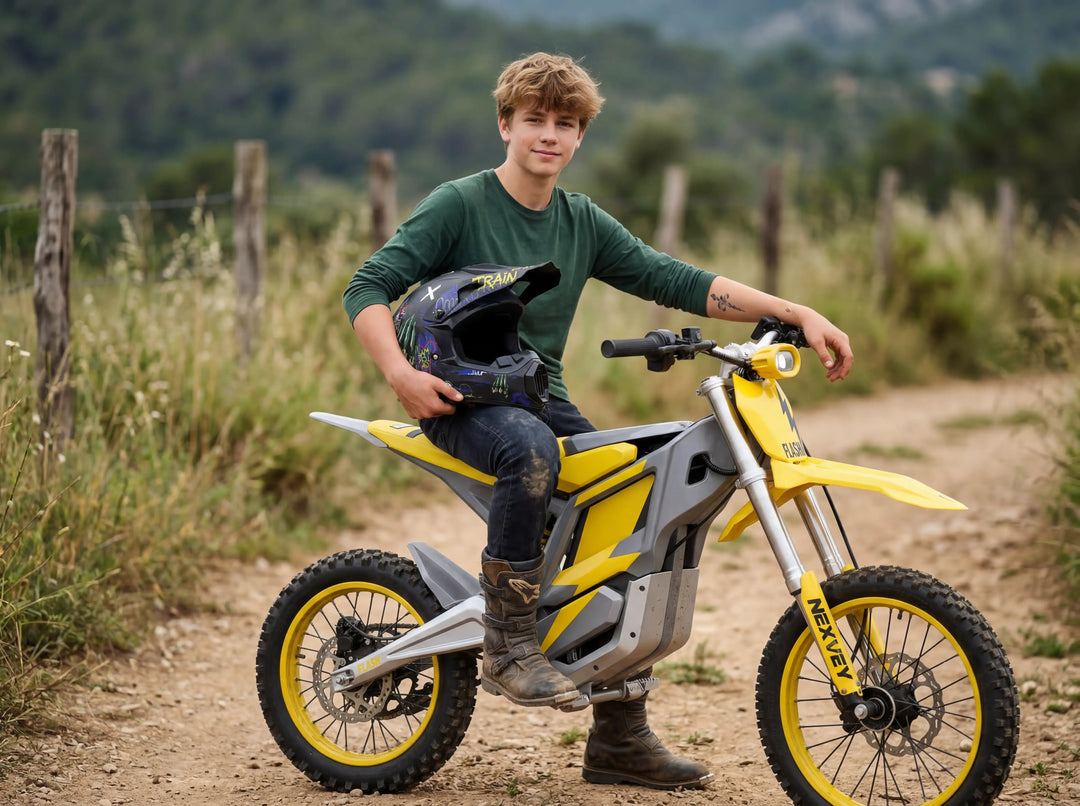 Youth rider on a yellow and grey NEXVEY electric dirt bike for kids, holding a helmet on a trail