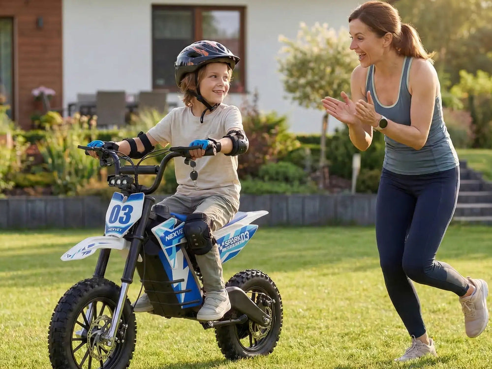 Teenager riding a blue electric motorcycle for youth with mother cheering in the background outdoors